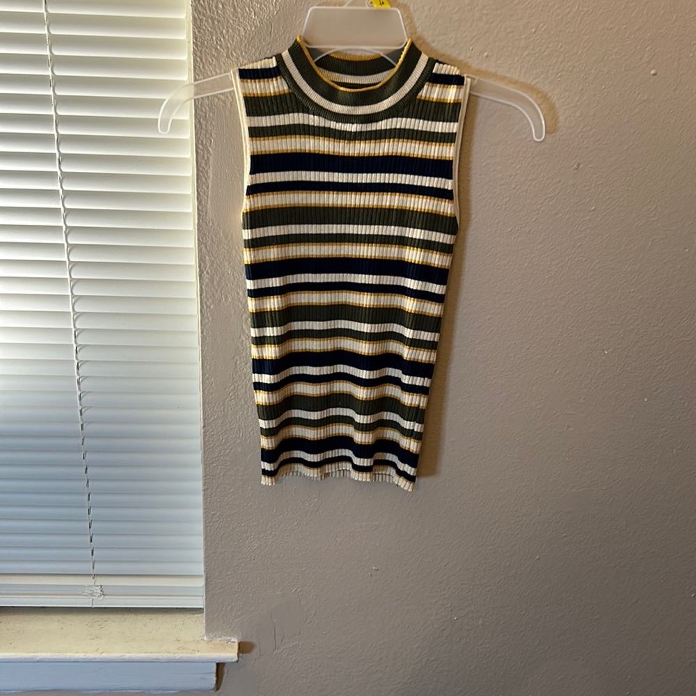Small sweater with no sleeves it’s navy blue yellow and green never been worn